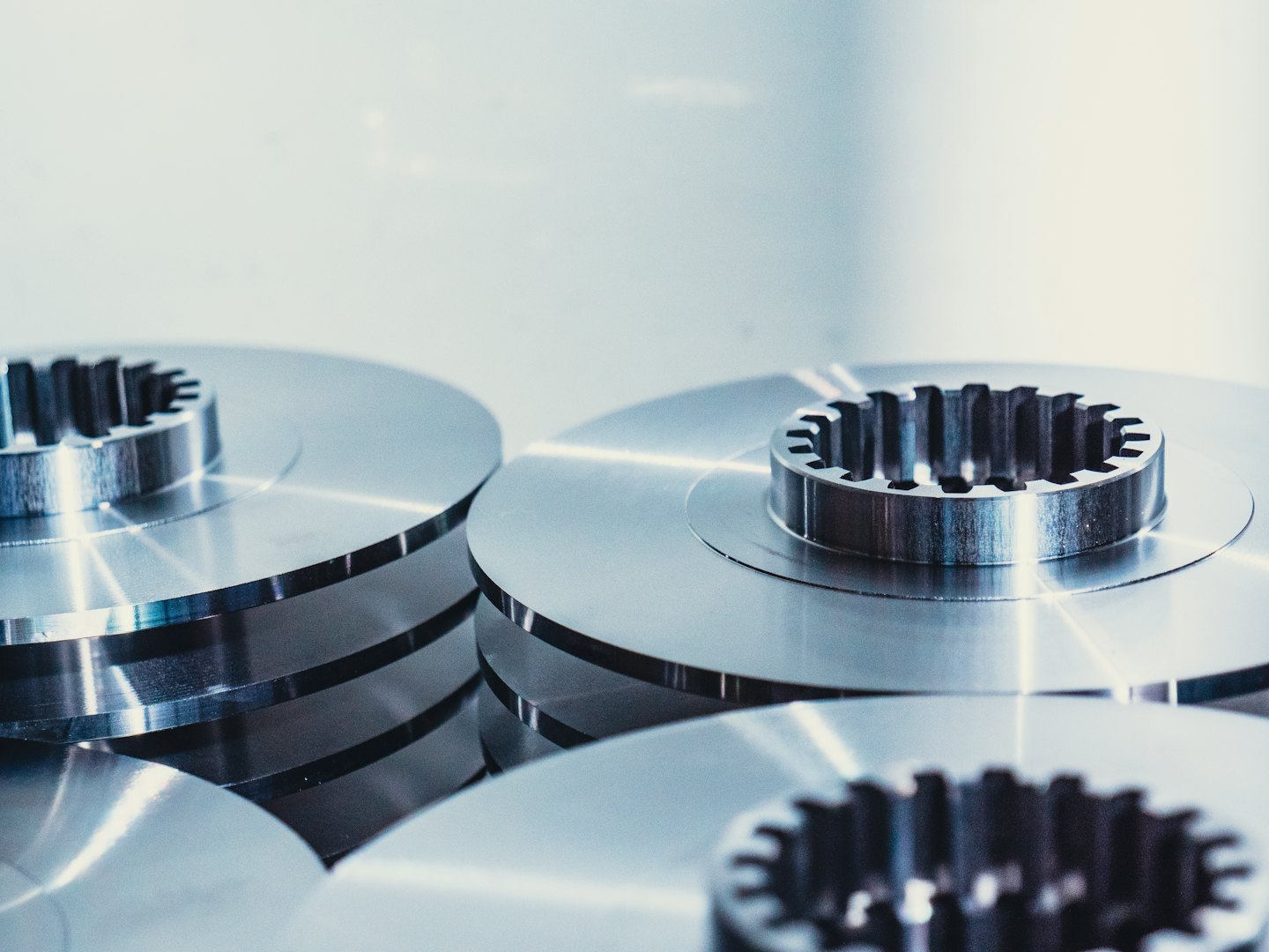 Glänzende metallische Industriekomponenten auf hellem Untergrund.